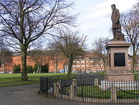 Statue of John Elder with his engine works in the background
