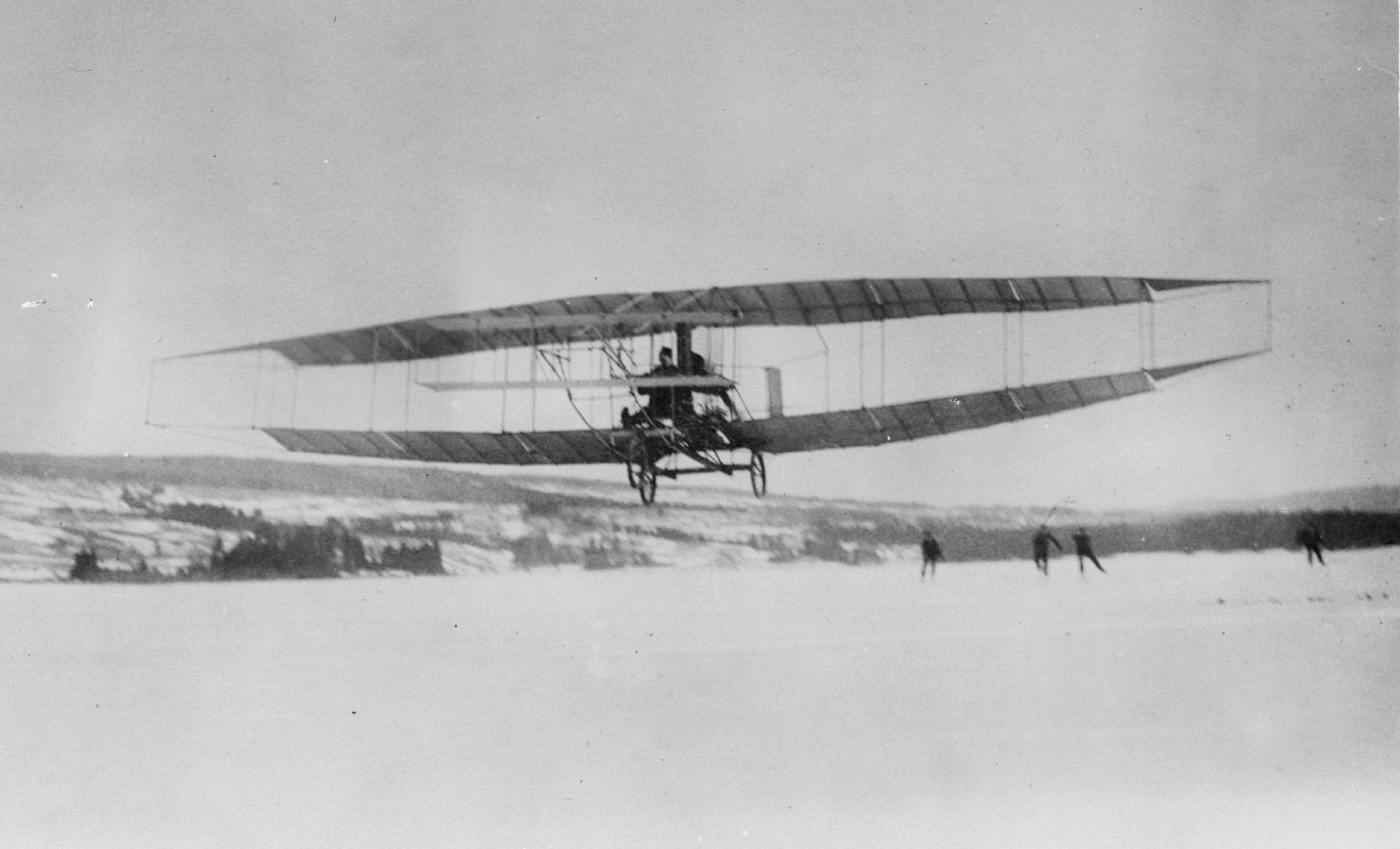 The Silver Dart biplane in 1909, the first powered aeroplane in&nbsp;Canada, here flying&nbsp;over the frozen Bras d'Or Lake on&nbsp;Cape Breton Island